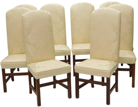 A set of eight mahogany dining chairs, each upholstered in gold coloured damask fabric to the back and seat, on plain legs, with stretchers. The upholstery in this lot does not comply with the 1988 (Fire & Fire Furnishing) Regulations, unless sold to a k