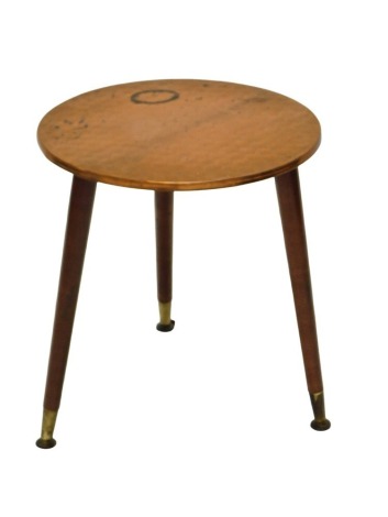 A 1950/60s occasional table, with copper hammered top, and turned tapering legs, 41cm high, 37cm diameter.