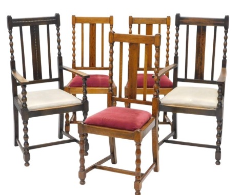 A set of five oak dining chairs, each with bobbin turned supports, drop in seat and H stretchers, colour variation between side chairs and carver chair.