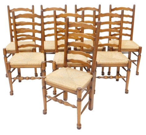 A set of eight oak ladder back dining chairs, each with a rush seat, 290cm long, one leaf of a later date, etc. (AF)