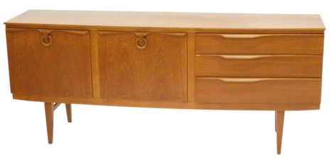 A Beautility teak bow fronted sideboard, with an arrangement of two doors and three drawers, on square tapering legs, 77.5cm high, 185cm wide.