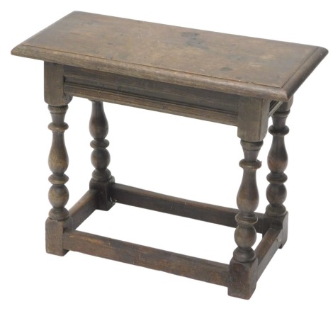 An oak joint stool, the rectangular top with a moulded edge, on turned supports, 63cm wide.