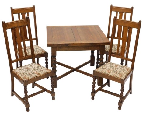 An oak draw leaf dining table, on spirally turned supports, and four oak dining chairs, the table 91cm long enclosed.