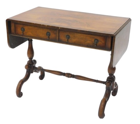 A walnut sofa table, in Regency style, the quarter veneered top with a top banded border above two frieze drawers, on turned end supports with splay legs, 91cm wide.