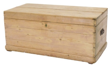 A stripped pine blanket box, the hinged lid enclosing a candle box, and small drawers, on a plinth, 108cm wide.