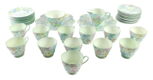 A Shelley Melody pattern part tea service, comprising two rectangular cake plates, milk jug, sugar bowl, twelve teacups, twelve saucers and twelve side plates.