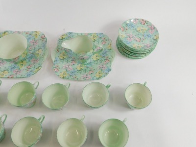 A Shelley Melody pattern part tea service, comprising two rectangular cake plates, milk jug, sugar bowl, twelve teacups, twelve saucers and twelve side plates. - 2