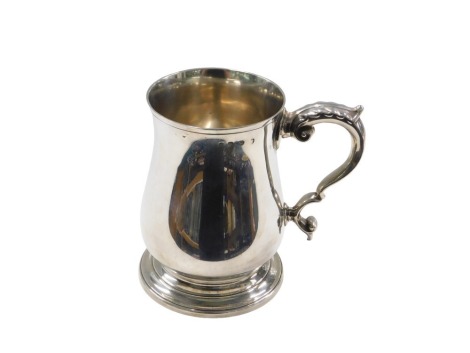 A Victorian silver tankard, with leaf moulded handle, on plain design stepped foot, hallmark rubbed, London Assay, 12.5cm high, 11oz.