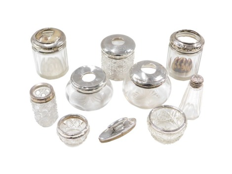 A group of pressed glass and silver rimmed dressing table jars, hat pin jars, nail buffer, etc., George V and later. (AF)