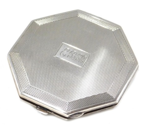 A George V silver compact, of octagonal form, with engine engraved decoration, bearing the initials EBK, maker D & P, Birmingham 1914, 2oz gross.