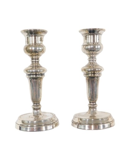 A pair of George V silver candlesticks, of tapered form, London 1935, on weighted bases, 13cm high.