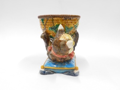 A Majolica centrepiece or jardiniere, modelled in the form of cat holding a basket, seated on a turquoise coloured cushion with gold piping, bearing Minton name to underside, 27cm high, 35cm wide. - 4