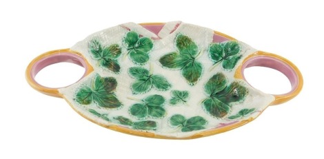 A 19thC Majolica dish, on a turquoise ground with moulded green leaves, and pink and orange handles, 37cm diameter.