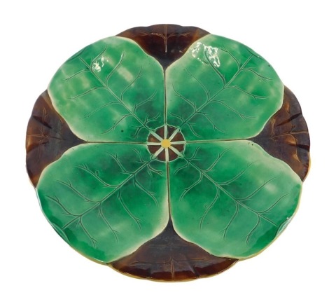 A 19thC Majolica wall plate, on a brown ground with green leaf decoration, 39cm diameter.