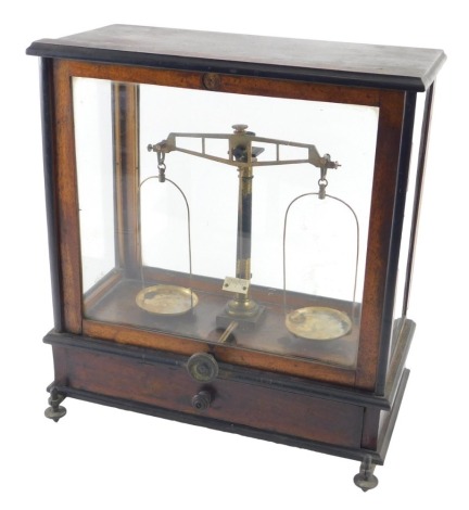 A set of lacquered brass chemist or laboratory scales, in mahogany case, with adjustable feet, 38cm high, 35cm wide.