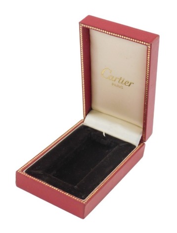 A box for a Cartier cigarette lighter in red, stamped Cartier Paris.