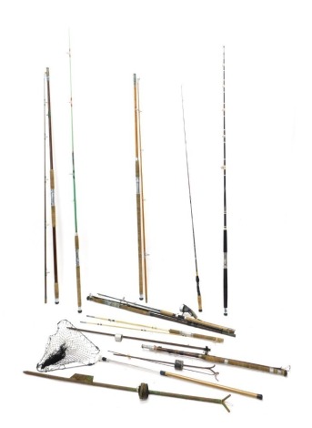 A quantity of fishing tackle, to include various rods, nets, mahogany and brass Scarborough type reel, other accessories, etc.