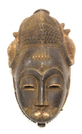 Tribal Art. Baule/Baoule, Mblo portrait mask with traditional Ashanti coiffure, crack to right cheek, Cote D'Ivoire, 31cm high.