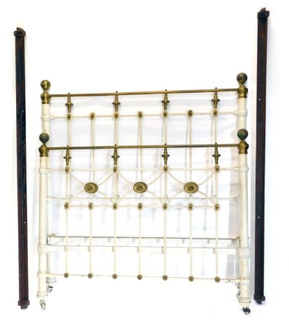 A late Victorian cast iron and brass bed head and foot, 136cm wide.