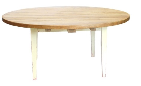 A large distressed pine dining table, the circular planked top on cream painted square tapering legs, 78cm high, 176.5cm diameter.