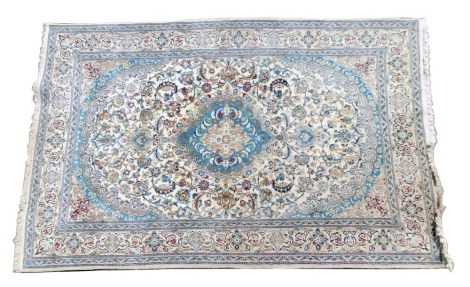 A Persian style carpet, with a central medallion in shades of blue, on a cream ground, one wide and two narrow borders, 298cm x 191cm.