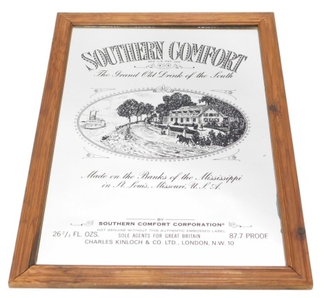 A Southern Comfort advertising mirror, in moulded pine frame, 93cm high, 66cm wide.