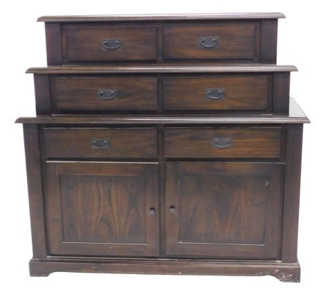 An Indonesian Old Java hardwood chest, of stepped form, with six drawers and two panelled doors, on bracket feet, 125cm high, 131cm wide, 48cm deep.