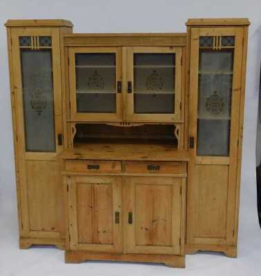 A Victorian pine breakfront cabinet, the central section with frosted glass doors enclosing three shelves with recess, the base with two drawers above two cupboards, flanked by two long cupboards with part frosted glass doors enclosing an arrangement of s - 2