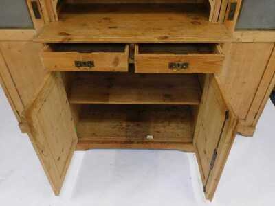 A Victorian pine breakfront cabinet, the central section with frosted glass doors enclosing three shelves with recess, the base with two drawers above two cupboards, flanked by two long cupboards with part frosted glass doors enclosing an arrangement of s - 3