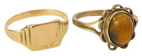 Two dress rings, comprising a 9ct gold signet ring, with rectangular panel, lacking initials, ring size P, and a tiger's eye set 9ct gold cluster ring, ring size N½, 4.9g all in. (2)