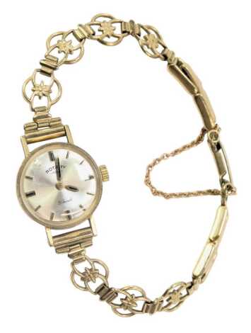 A Rotary 9ct gold cased lady's wristwatch, the silvered dial with twenty one jewel movement, of pierced design floral bracelet, 1.5cm wide, 12.2g all in.