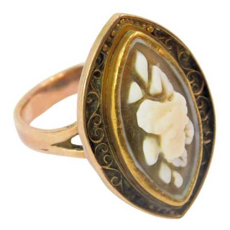 A Victorian dress ring, the marquise shaped top set with raised cameo of flowers, with filigree scroll outer border, on a yellow metal band with V splayed shoulders, ring size S, 5.6g all in.