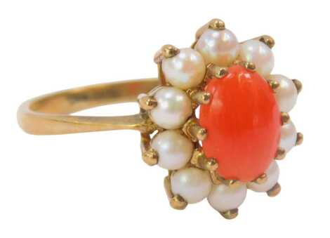 A 9ct gold cluster ring, set with oval column, surrounded by seed pearls, each claw set, ring size P½, 2.3g all in, boxed.