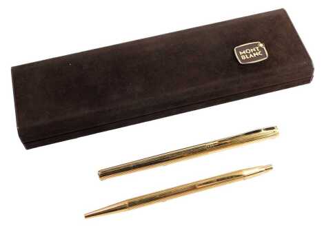 A Montblanc Noblelist fountain and ballpoint pen set, in gold coloured casing, of fluted design, the fountain pen nib marked 585, boxed.