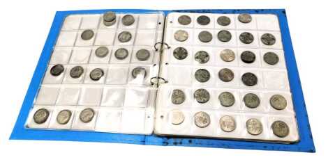 An album containing Victorian and later pre decimal coinage, comprising florins, shillings, and two shillings, enclosed in an album.