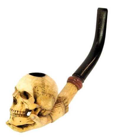 A meerschaum pipe, carved as a skull being held by professor's hand, unmarked, 20cm long.