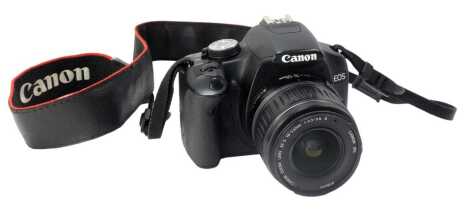 A Canon EOS 500D camera, with ef-s 18-55mm lens, charger cable and accessories.