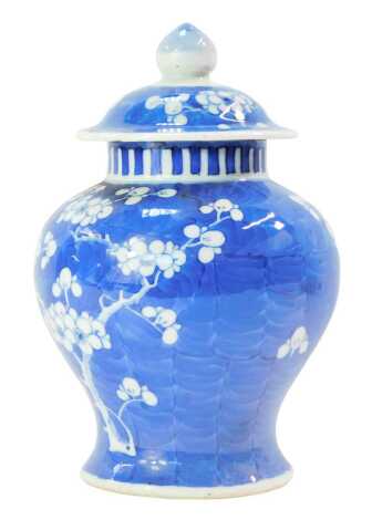 A Qing Dynasty Chinese porcelain ginger jar and cover, with prunus blossom in blue and white, 21cm high. (cover AF)