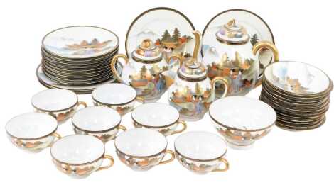 An early 20thC Japanese eggshell china tea service, with gilt decoration and landscape probably Mount Fuji and geishas.