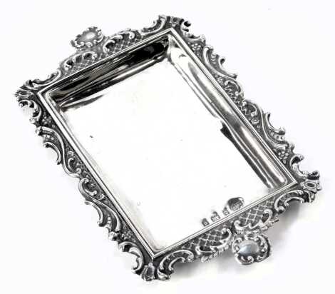 An Edward VII silver pin tray, with pierced scroll border, vacant cartouche handles, maker AR, Birmingham 1903, 0.95oz, 12cm wide.