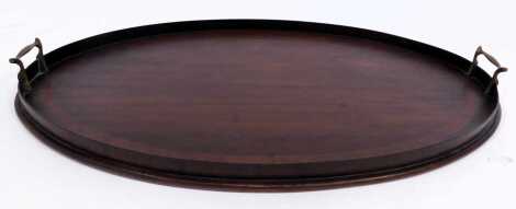 A 19thC mahogany and cross banded oval tray, with two brass ring handles, 66cm wide.