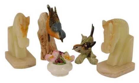 A pair of carved horse head onyx bookends, 14cm high, together with a Goebel porcelain figure modelled as a Nut Hatch and a Fire Crest, and a Royal Albert Christmas Rose porcelain posy, 6cm high. (AF)