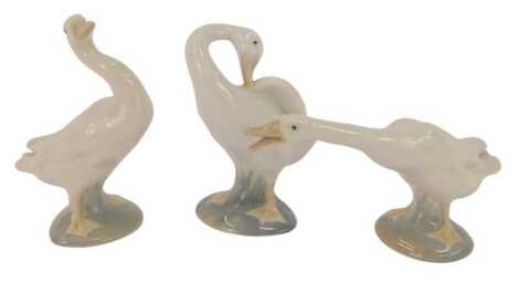 Three Lladro porcelain figures modelled as geese, in differing poses, the largest 12cm high.