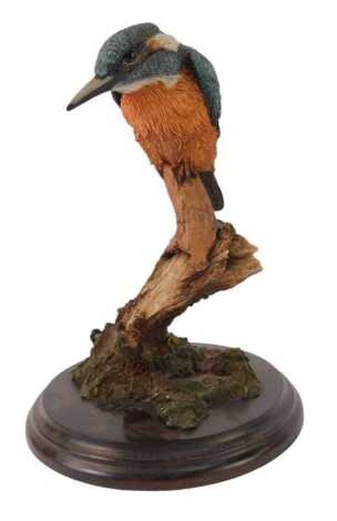 A Country Artists resin figure modelled as a kingfisher on branch, on a circular hardwood stand, 21cm high.