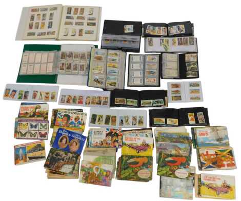 Cigarette cards and tea cards, some in albums, to include Brooke Bond Wild Flowers, The Race into Space, All Stars World Cup 1978, etc. (1 shelf)