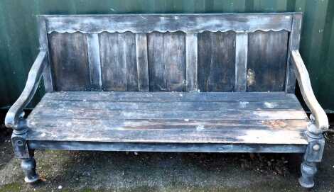 A pine bench, with raised back and scroll arm, five slatted base. (AF)