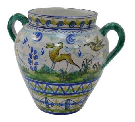 An Italian tin glazed two handled vase, depicting a figure with gun to the front and verso two hares, 24cm high.