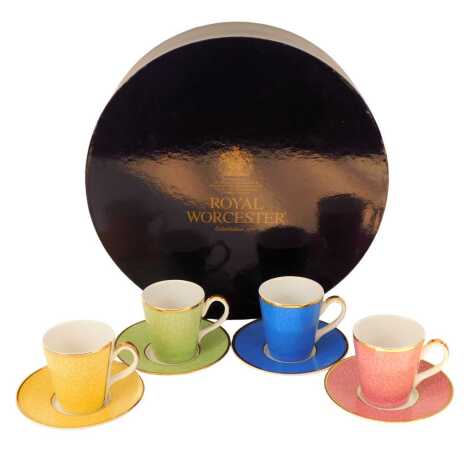 A Royal Worcester four piece porcelain coffee service, in Celebration of HRH 80th Birthday, in blue, yellow, pink and green, boxed.