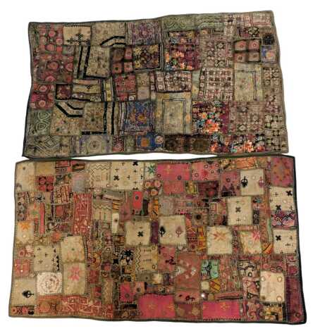 Two Indian patchwork wall hangings, decorated in differing fabrics with mirrored roundels, 64cm x 104cm each. (2)