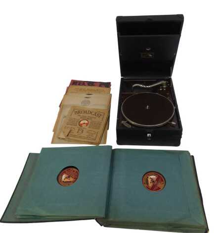 A His Master's Voice tabletop record player, together with various LPs and 78rpm records.